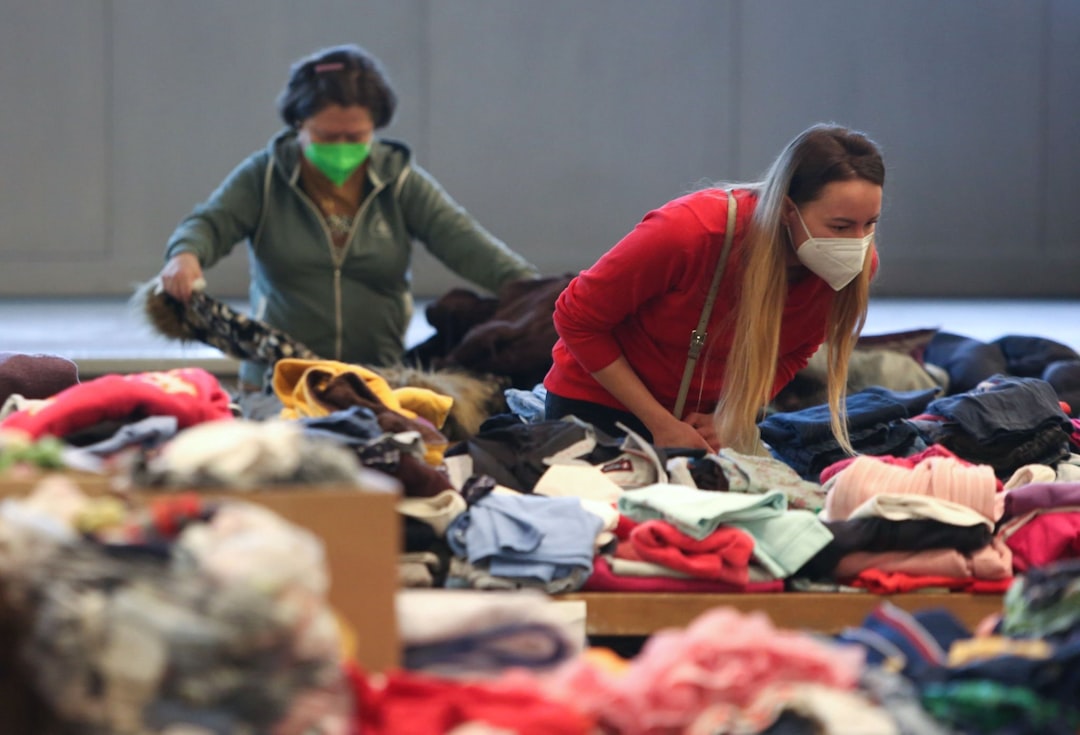 Workers sorting through clothing donations in a nonprofit facility representing the supply chain of second hand clothes from canada and the USA