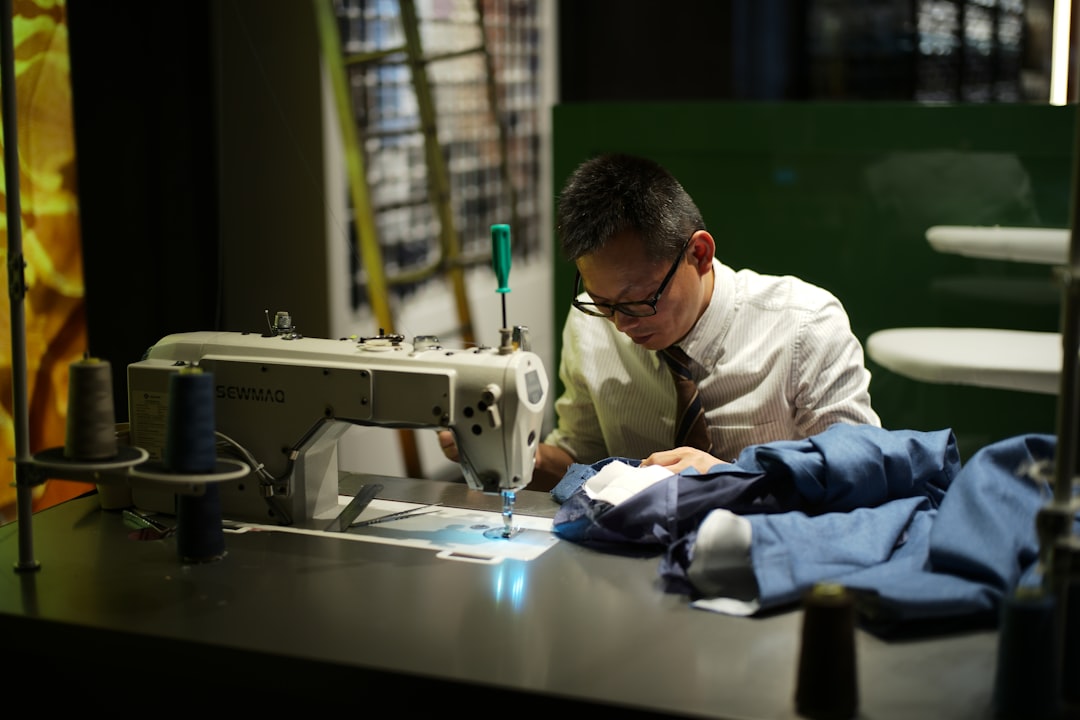 Woman inspecting fabric quality in a garment factory, representing the manufacturing standards of wholesale clothing suppliers in Guangzhou