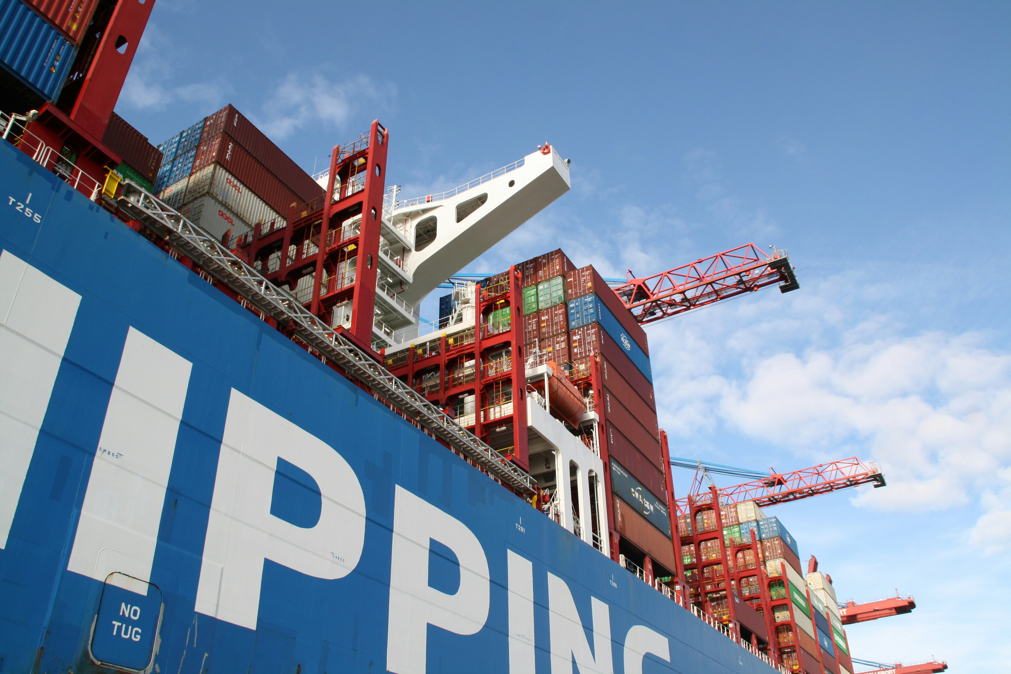 Large cargo ship at port representing the global shipping infrastructure that connects Guangzhou clothing suppliers to international buyers worldwide