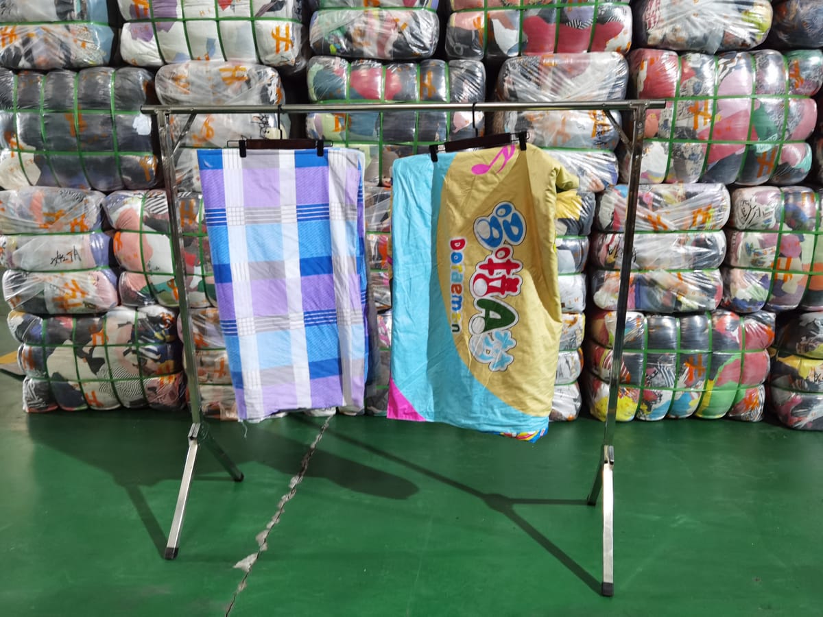Quilt covers and bedding — examples of heavier category items in used clothing bales