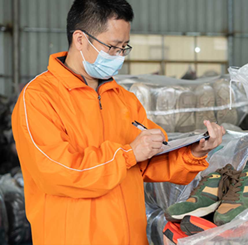 worker-is-checking-mixed-used-shoes