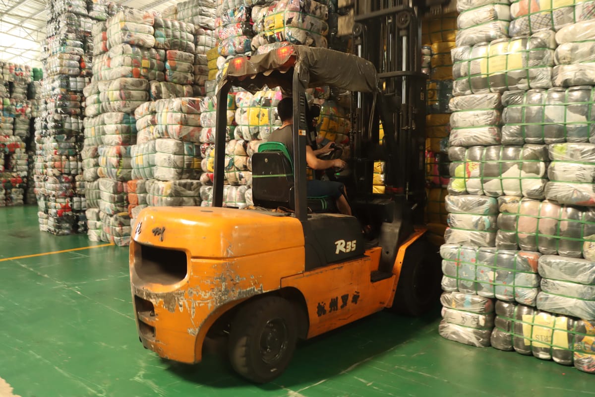 Used clothing bales being packaged and prepared for container shipment with organized labeling