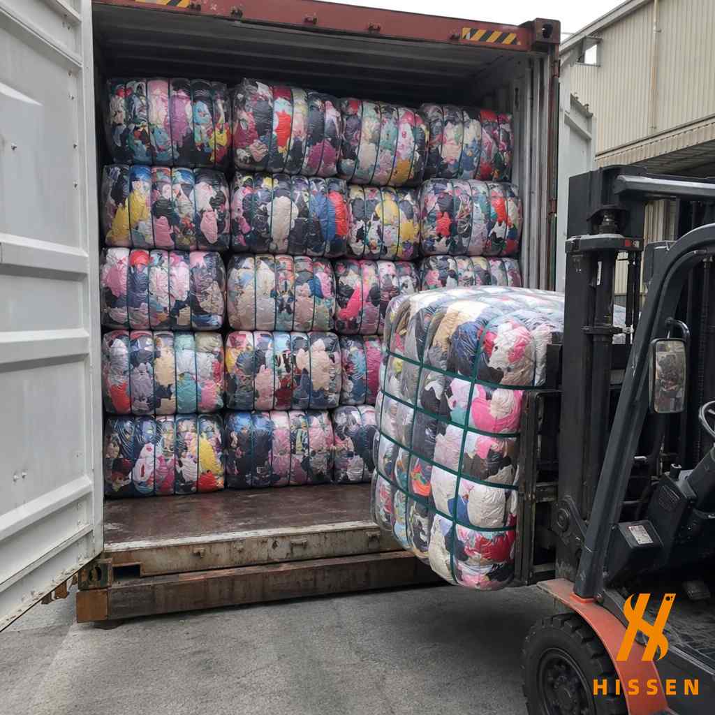 Container filled with childrens clothing bales being loaded for export