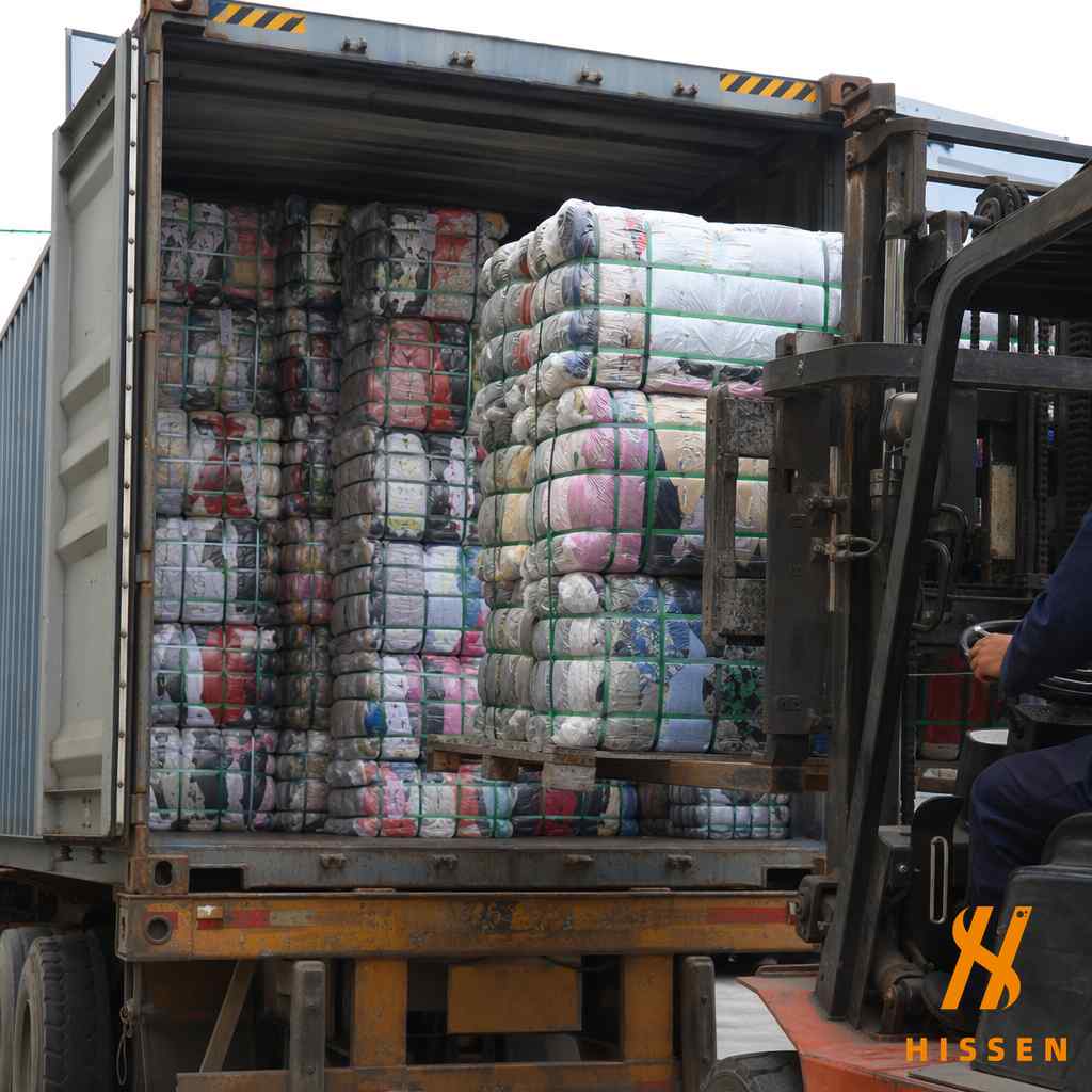 Premium high quality sorted secondhand clothing bales being loaded into a shipping container