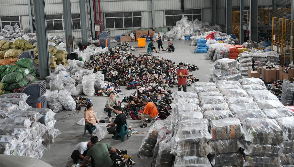 Inside a Chinese shoe sorting and processing facility showing organized workflow for used shoe export
