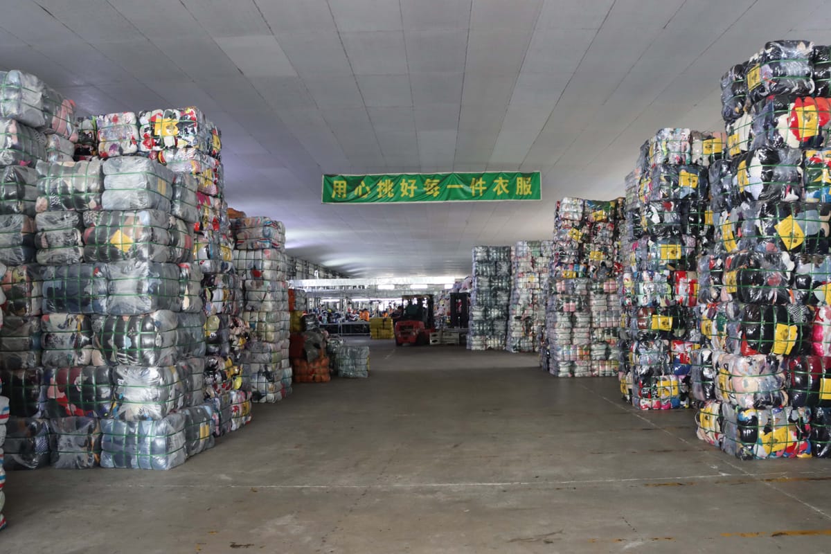 Organized used clothing sorting and grading warehouse in China showing European-inspired quality standards