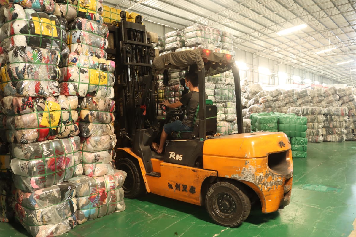 Container loading and shipping logistics operation showing organized export process with tracking capability
