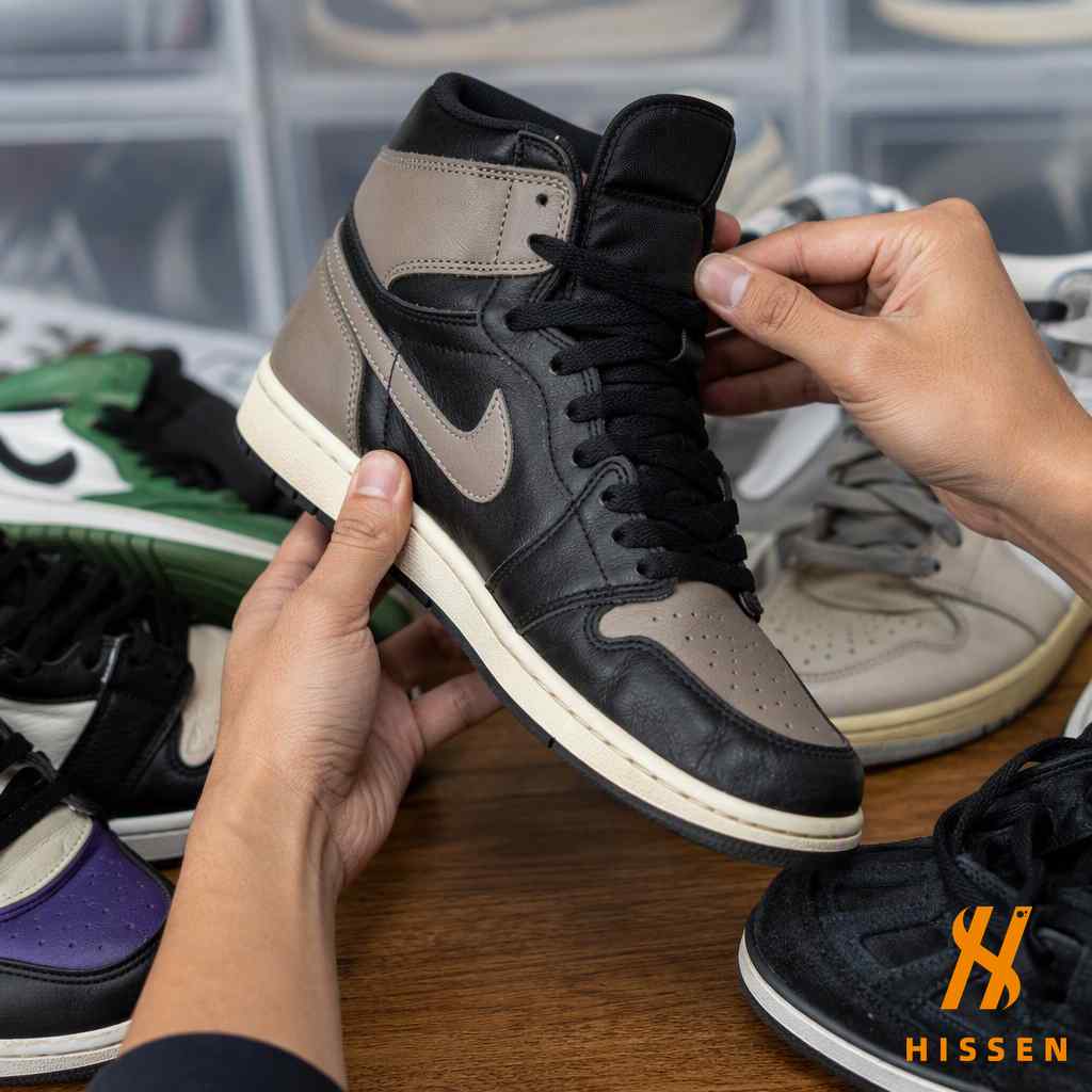 Hands examining second hand sneakers checking uppers soles and laces