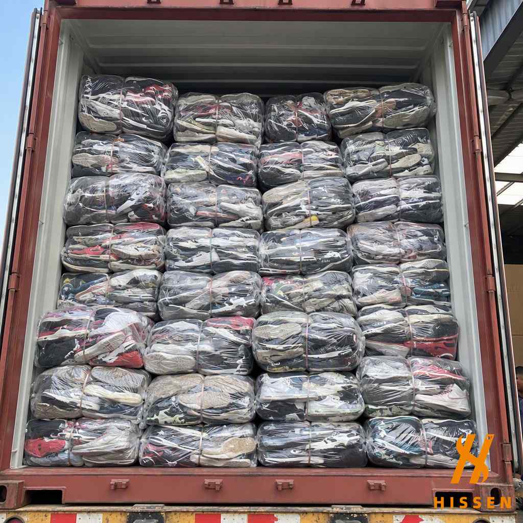 Wholesale container of second hand sneakers being loaded for export